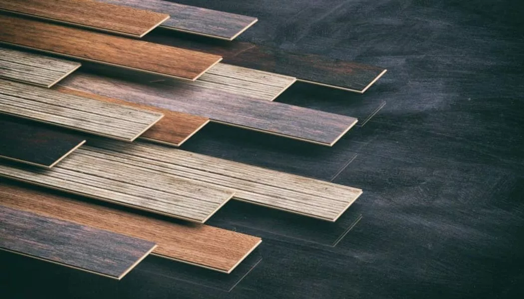 laminate, engineered, and solid hardwood planks laid out on a display floor