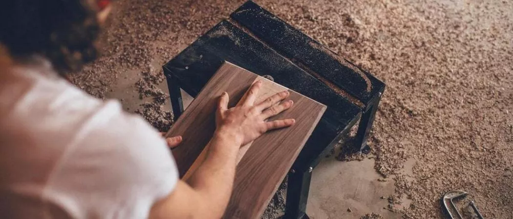 man measuring hardwood for a cut