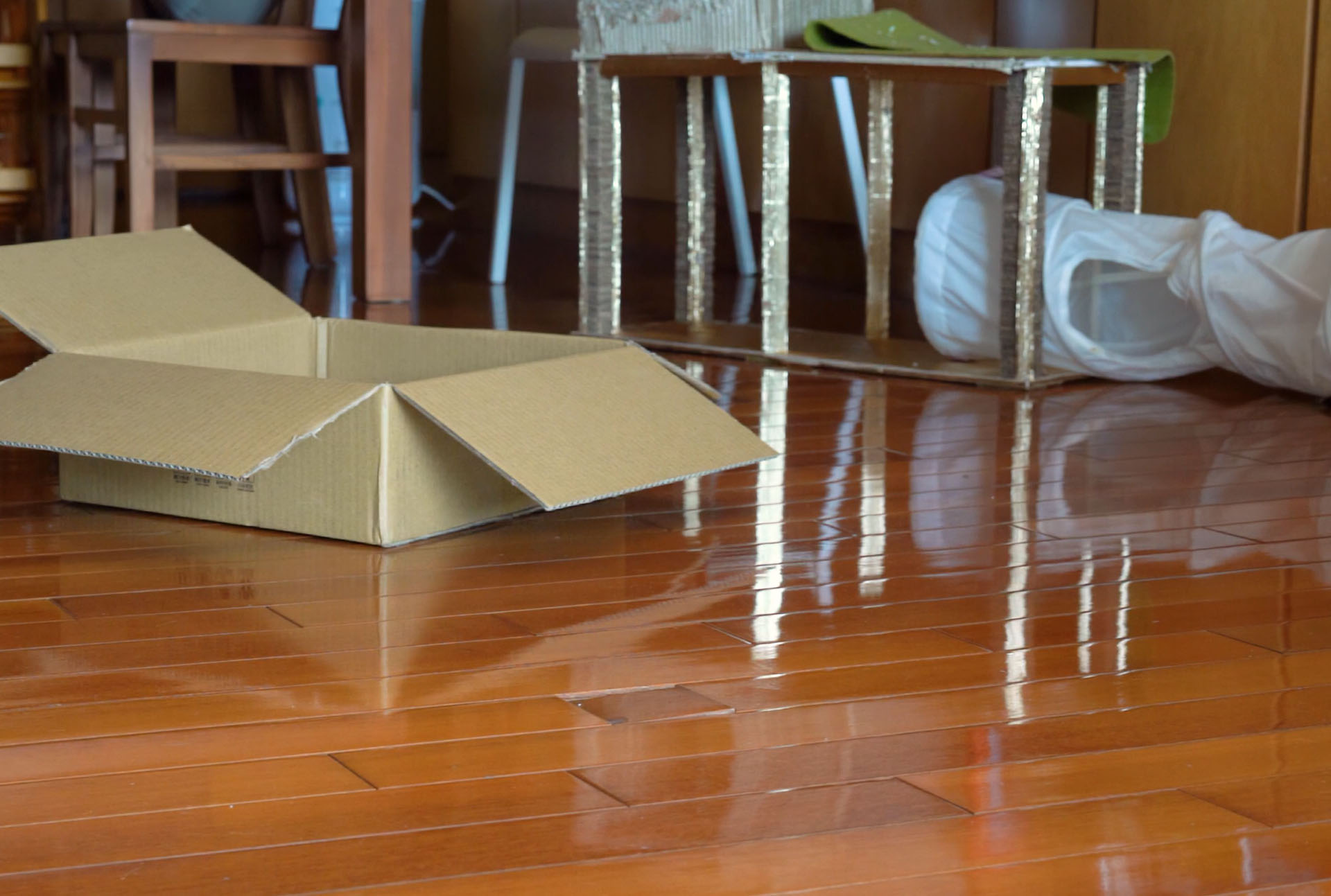 shiny hardwood floor with amazon boxes around picture