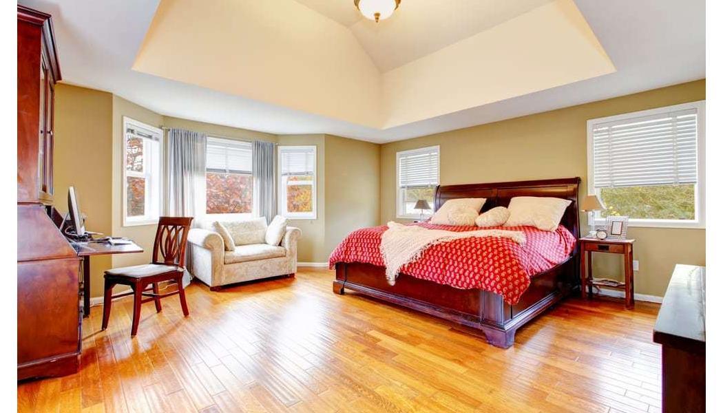 huge bedroom with high gloss hardwood floors