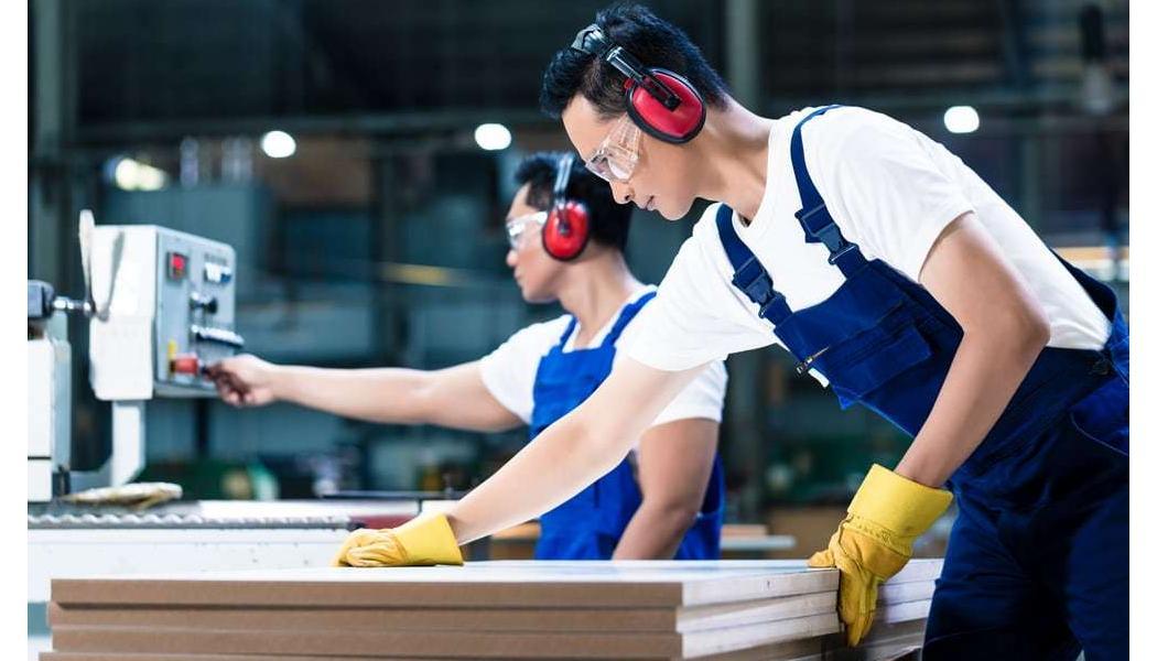 men putting engineered floors core material together